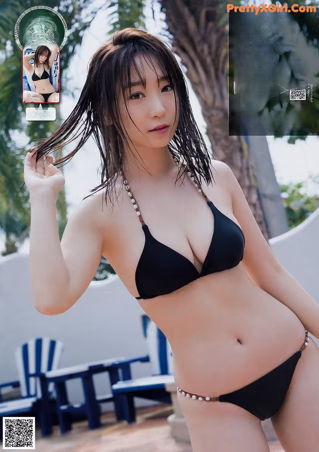 A woman in a black bikini posing by a pool.